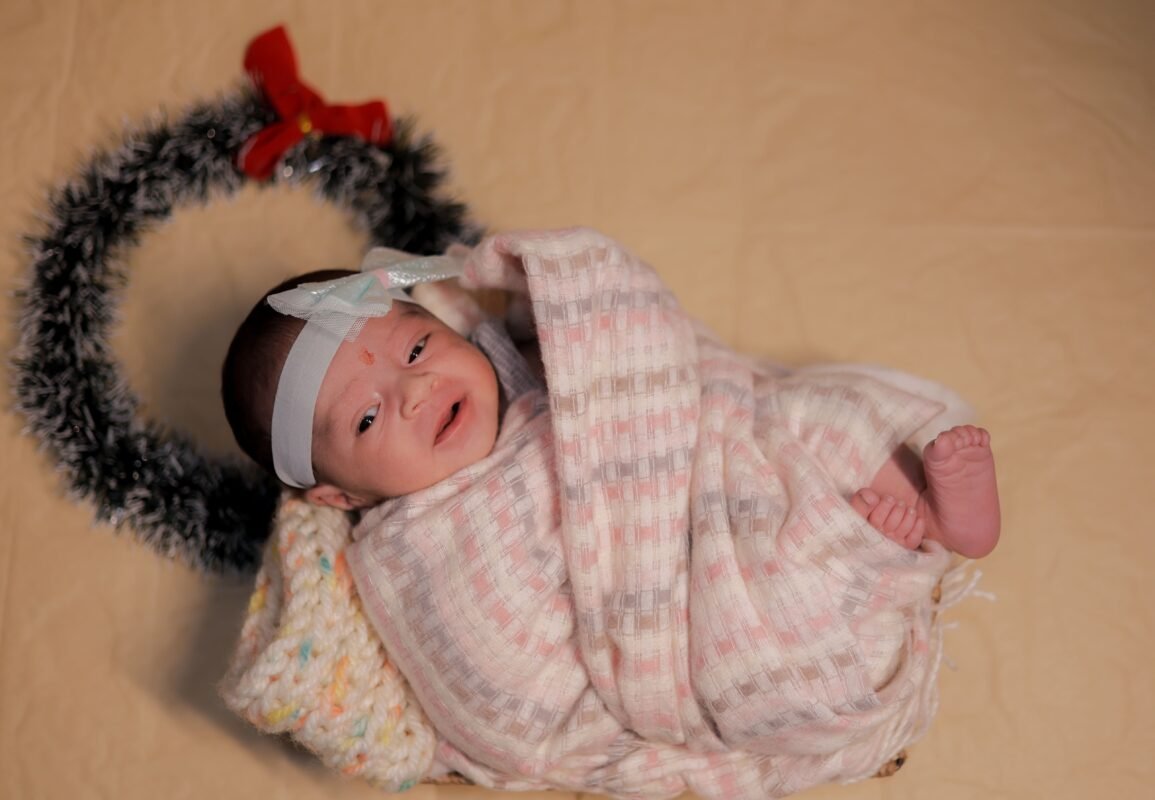 Sleeping newborn baby portrait with cute baby cap and soft blanket