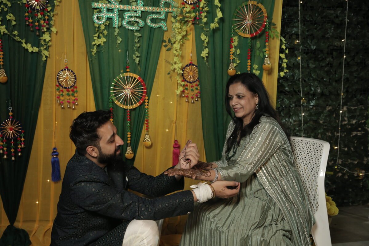 Romantic groom mehndi photography with traditional décor and candid wedding emotions – Gurgaon