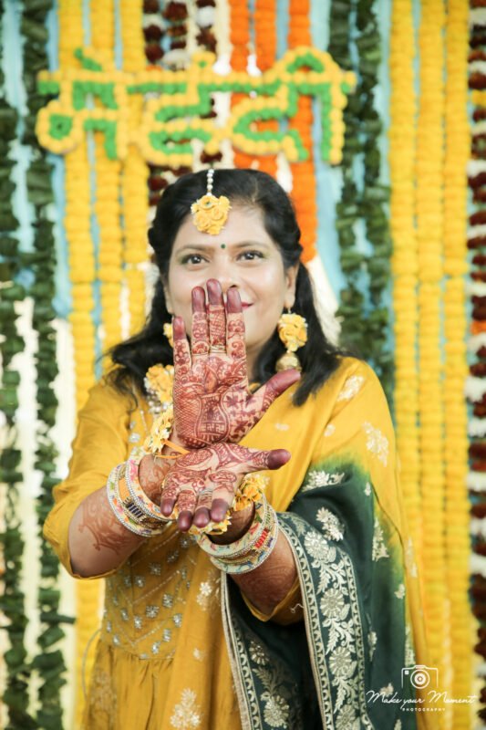 Bride showing mehndi hands close up during mehndi ceremony