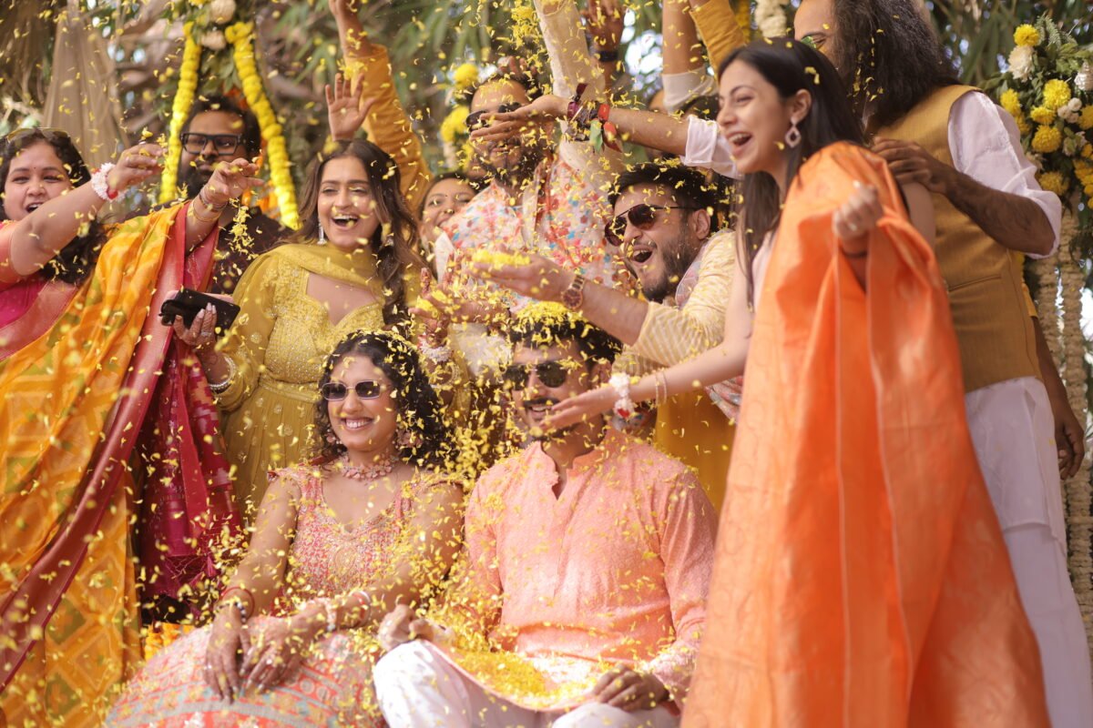 Haldi ceremony celebration with family and friends throwing flowers