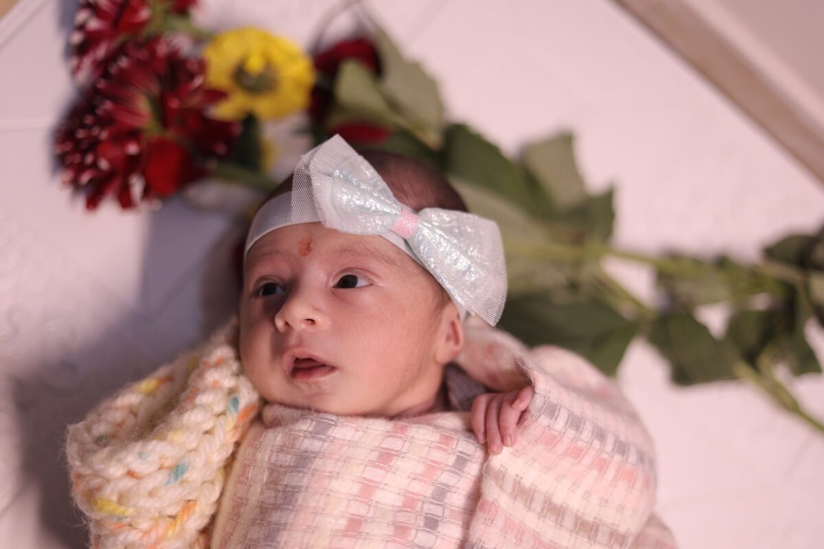 Newborn baby wearing bow headband