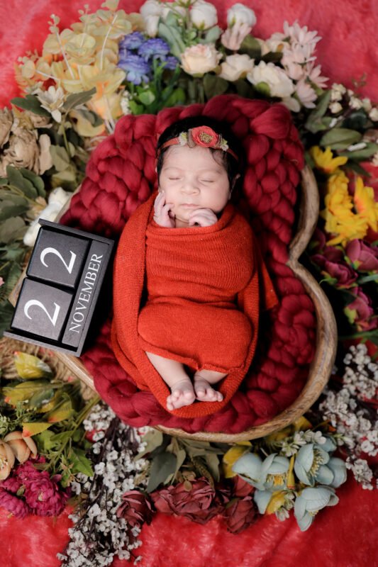 newborn baby milestone photoshoot with number board