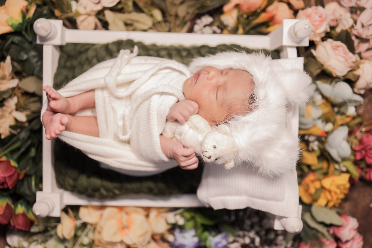 newborn baby lying on bed photoshoot creative baby photography