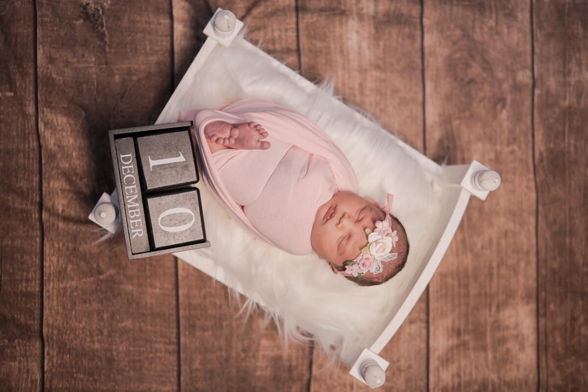 newborn baby lying on bed photoshoot creative baby photography
