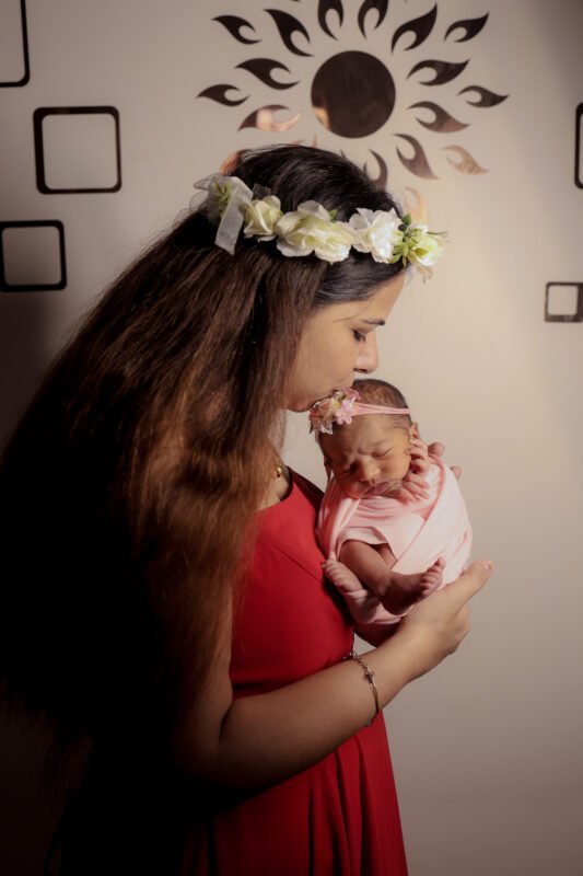 mother holding newborn baby photoshoot indoor professional