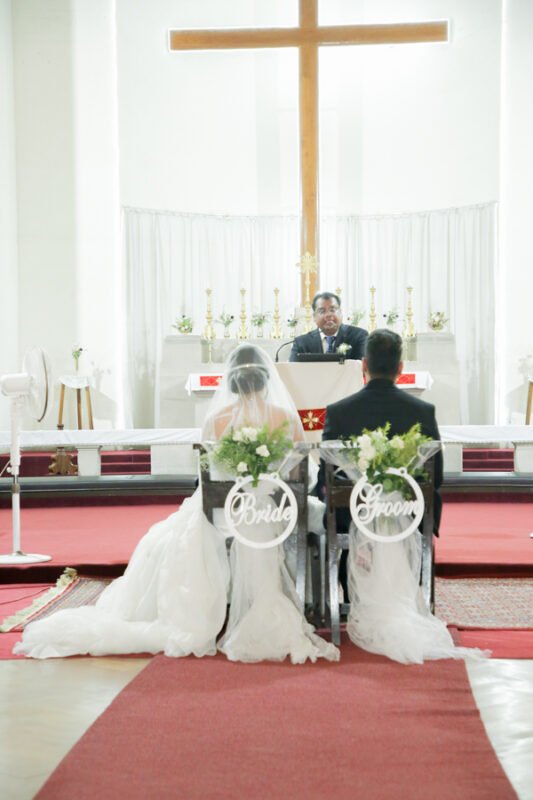 Wedding ceremony inside church with couple and priest Delhi NCR