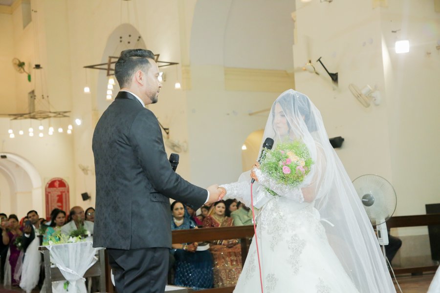 Groom putting ring on bride finger wedding ritual Delhi NCR