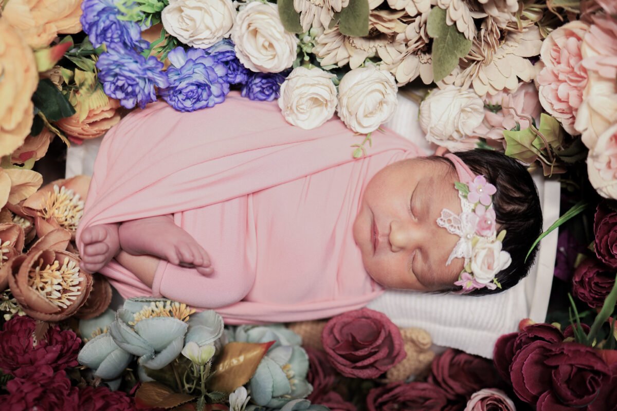 sleeping newborn baby wrapped in cloth professional baby shoot