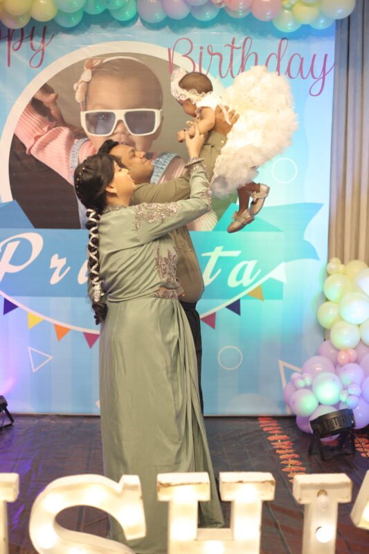 father holding baby birthday candid moment photography Delhi NCR
