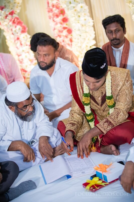 Muslim wedding nikah ceremony groom signing nikahnama candid moment