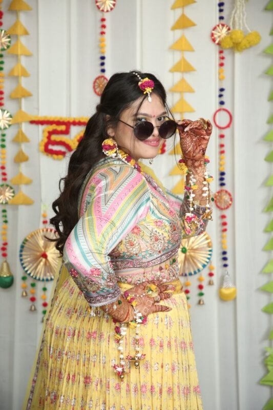 Elegant bride portrait during haldi function with floral decorations