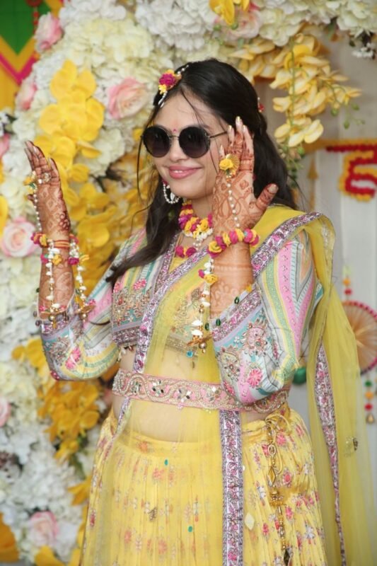 Bride portrait during haldi ceremony with colorful wedding décor