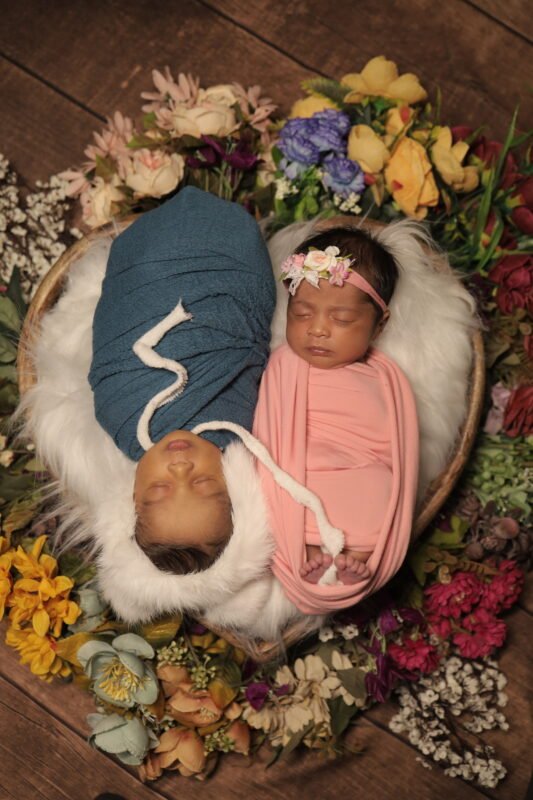 Twin newborn baby photography with floral setup in Delhi NCR