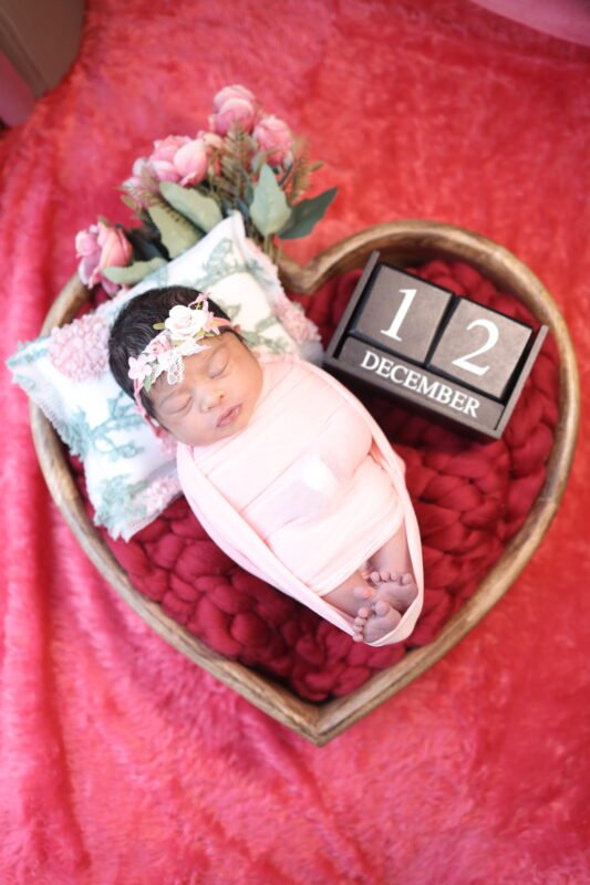 Creative newborn baby photoshoot in Delhi NCR with baby lying in a decorative basket by Make Your Moment Photography