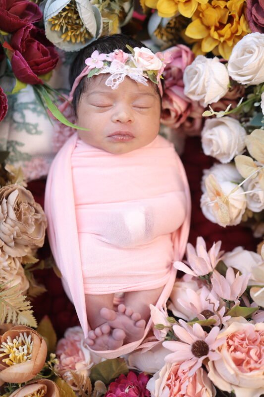 Cute newborn baby photoshoot in Delhi NCR with floral theme by Make Your Moment Photography