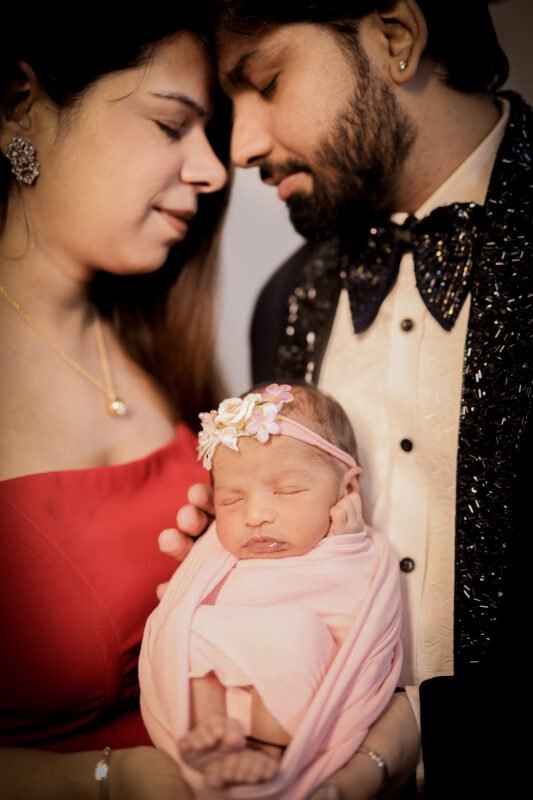 Newborn baby girl portrait with parents