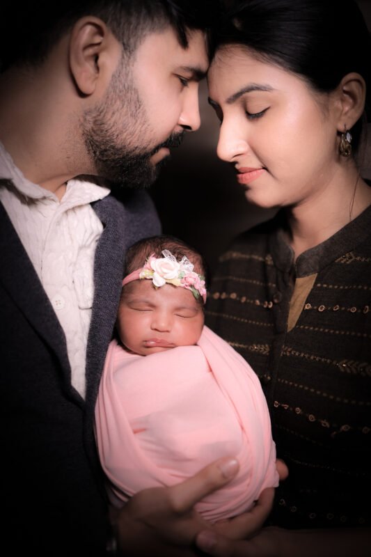 Newborn baby photoshoot with mom and dad in Noida