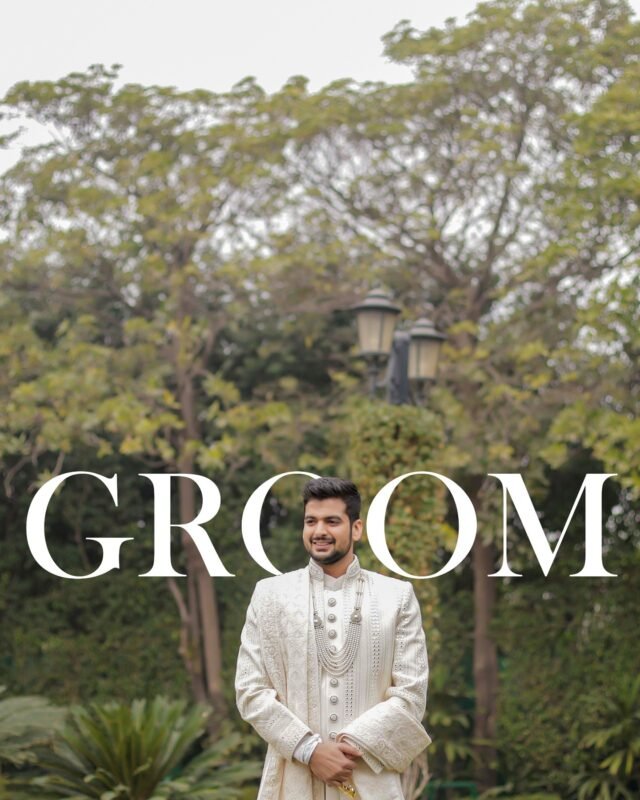 Indian groom posing in a lush garden.