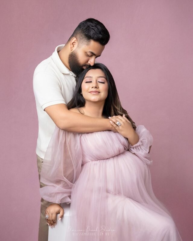 Professional maternity couple portrait in Delhi NCR with expecting father hugging mother during pregnancy photoshoot.