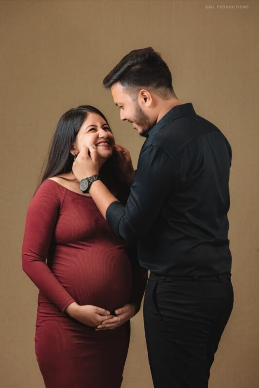 Luxury maternity photoshoot in Delhi NCR with expecting couple smiling together