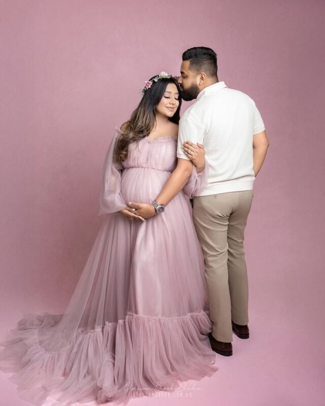 Luxury maternity couple photoshoot in Delhi NCR with expecting parents sharing a romantic pregnancy moment.