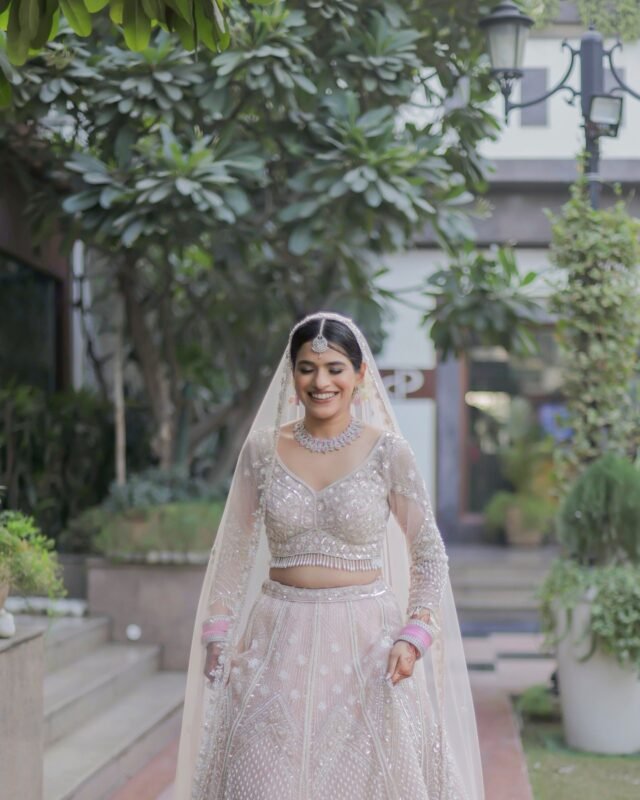 Indian bride walking in luxury bridal lehenga.