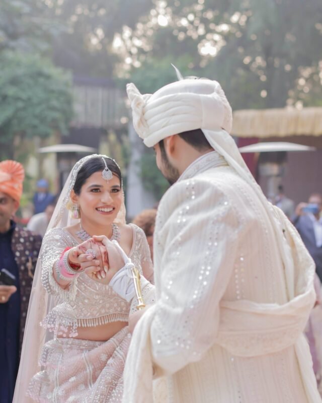 Bride holding groom's hand during wedding.