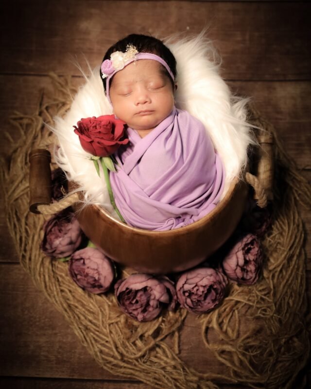 Newborn baby with rose