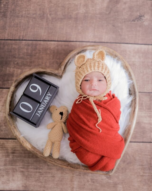 Newborn baby with date prop