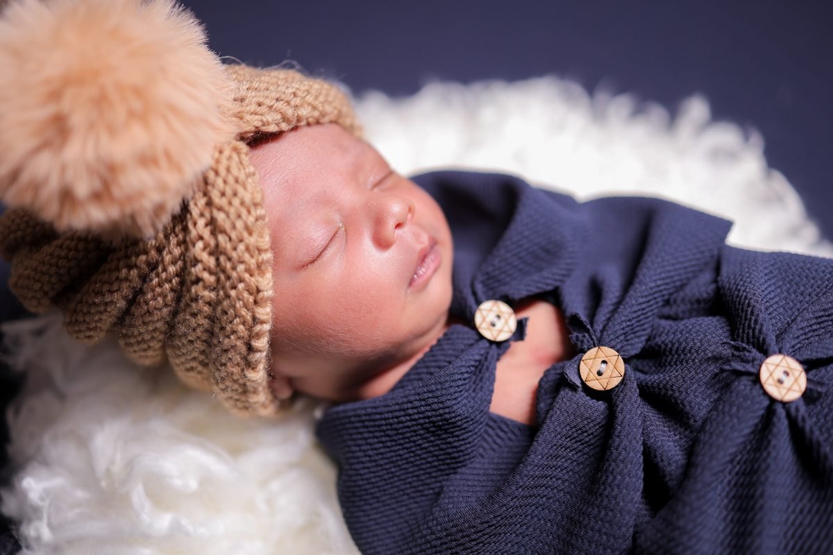 Newborn baby in blue outfit