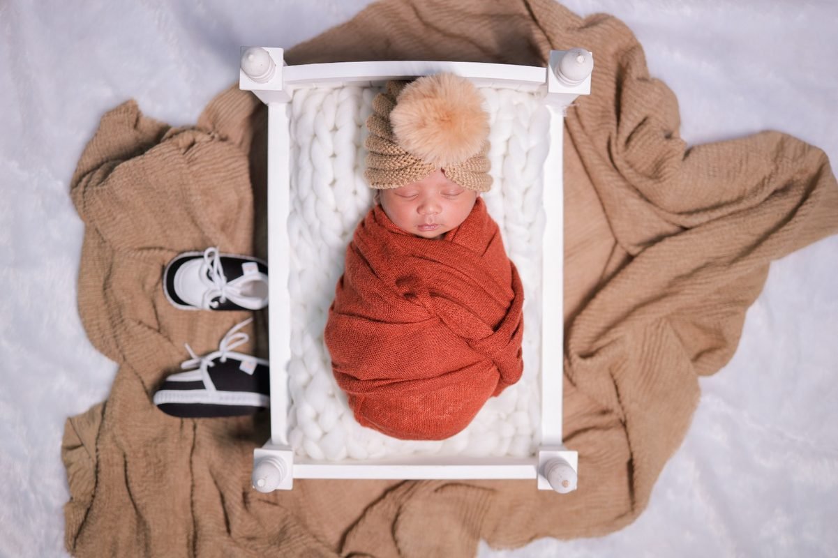 Newborn baby sleeping in basket