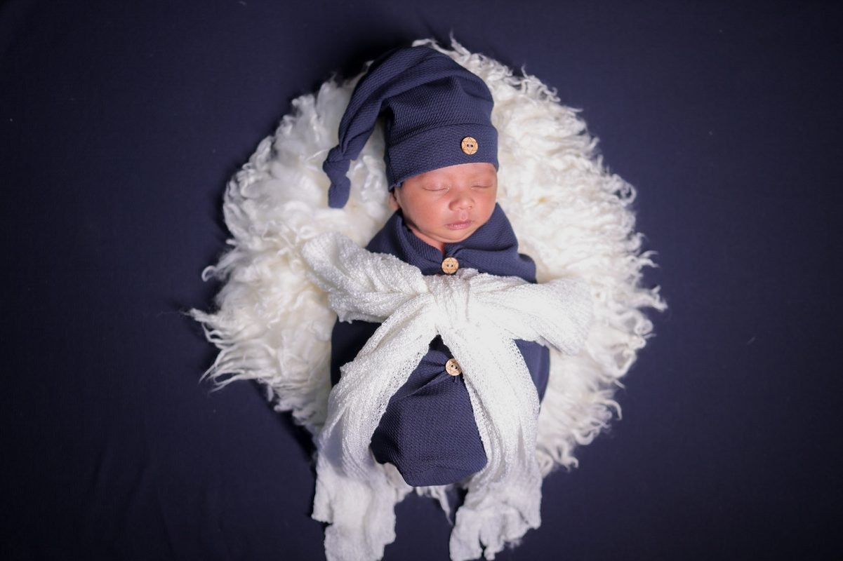 Newborn baby wrapped in white
